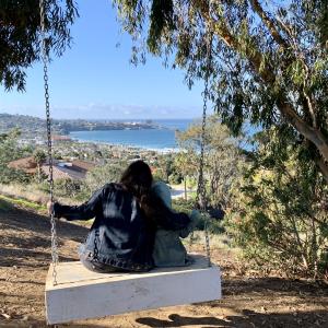 Hidden swing overlooking the Pacific and a quiet mommy-daughter moment. Hidden swing overlooking the Pacific and a quiet mommy-daughter moment.